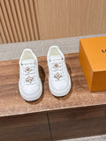 White Louis Vuitton sneakers with gold and pink floral/star charms