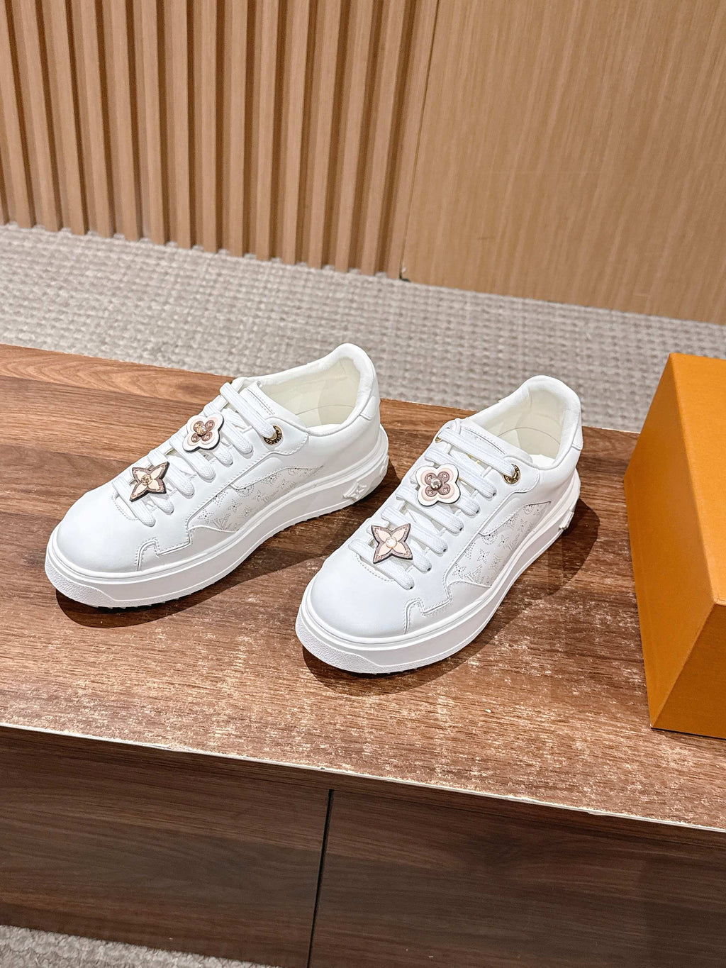 White Louis Vuitton sneakers, side view, gold star and flower appliques