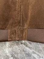Brown jacket hem with ribbed trim and vertical center zip seam