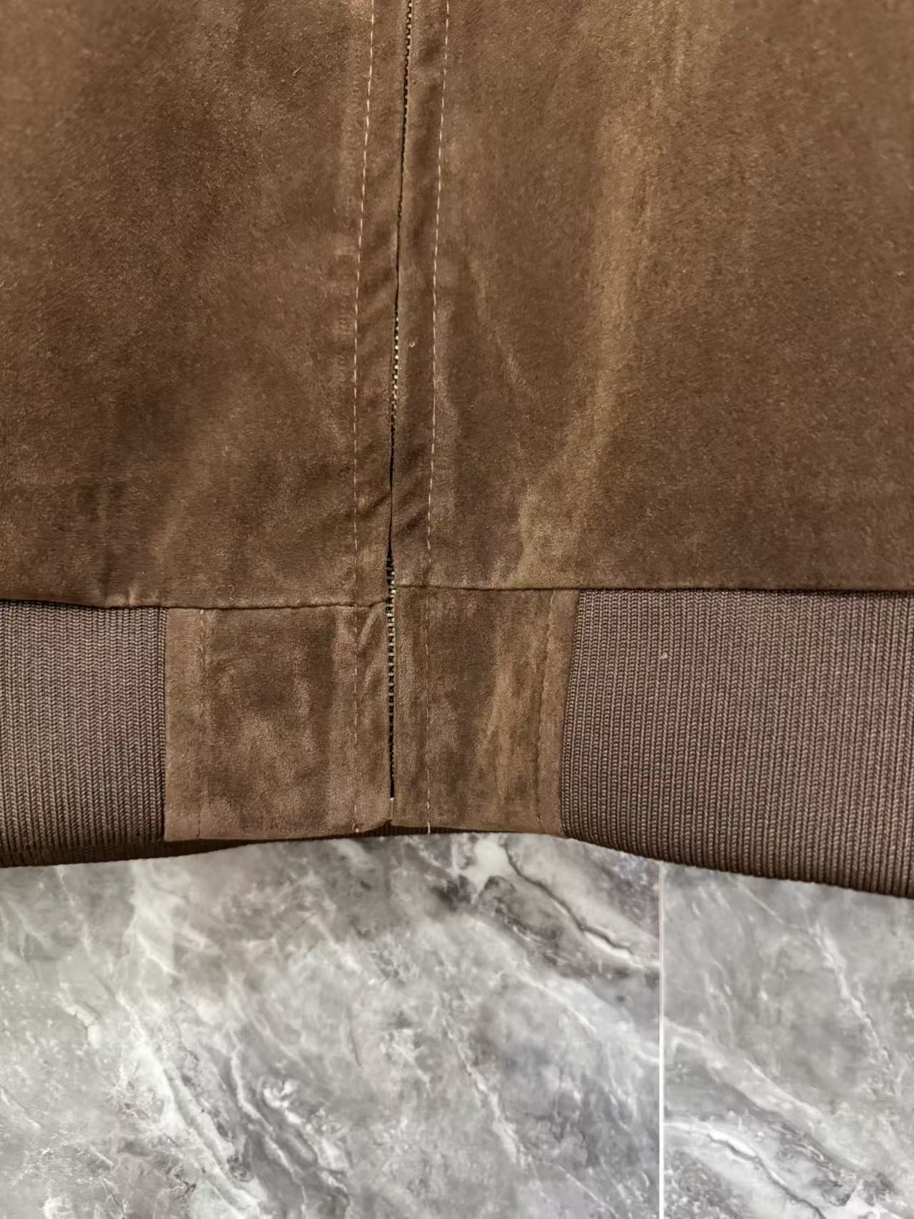 Brown jacket hem with ribbed trim and vertical center zip seam
