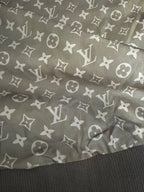 Brown patterned lining with repeating monogram icons and ribbed hem
