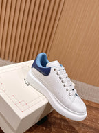 Alexander McQueen white leather sneaker with blue collar and lace-up, stitched detailing