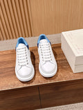Pair of white leather sneakers with blue collars and white lace-up uppers