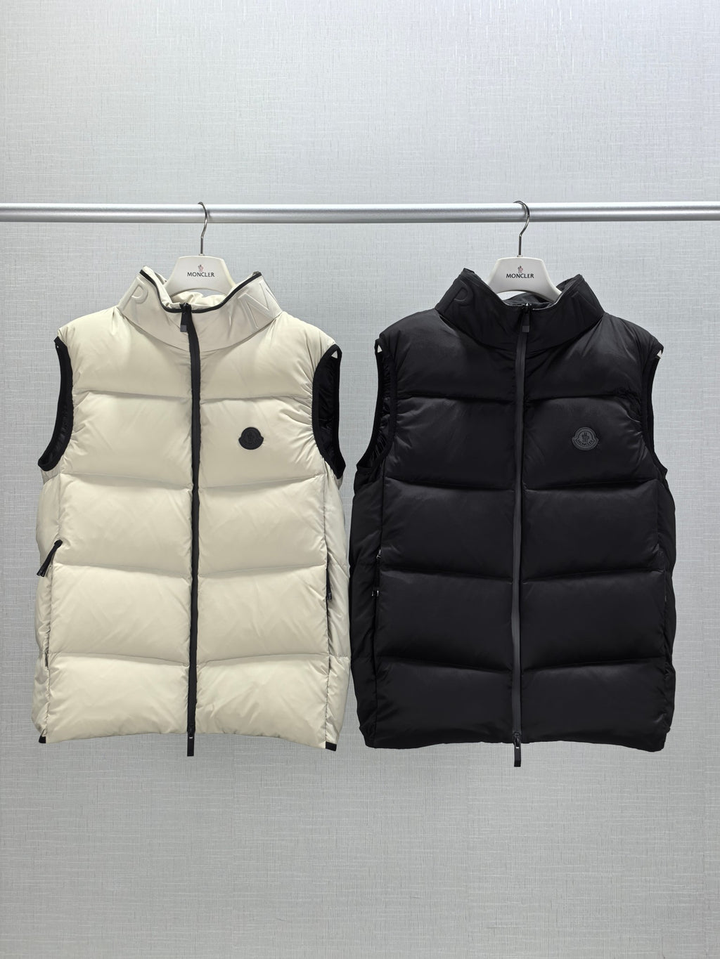 Quilted hooded puffer vests, light cream and black, front zipper and small logo