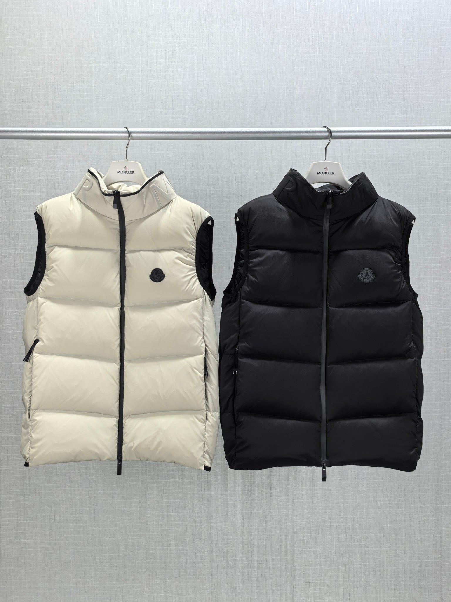 Quilted hooded puffer vests, light cream and black, front zipper and small logo
