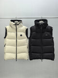 Quilted hooded puffer vests in light cream and black, zip-front with logo patch