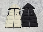 Flat lay quilted hooded puffer vests in light cream and black, zip-front
