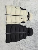 Sleeveless quilted puffer vests in light cream and black, side view with hoods
