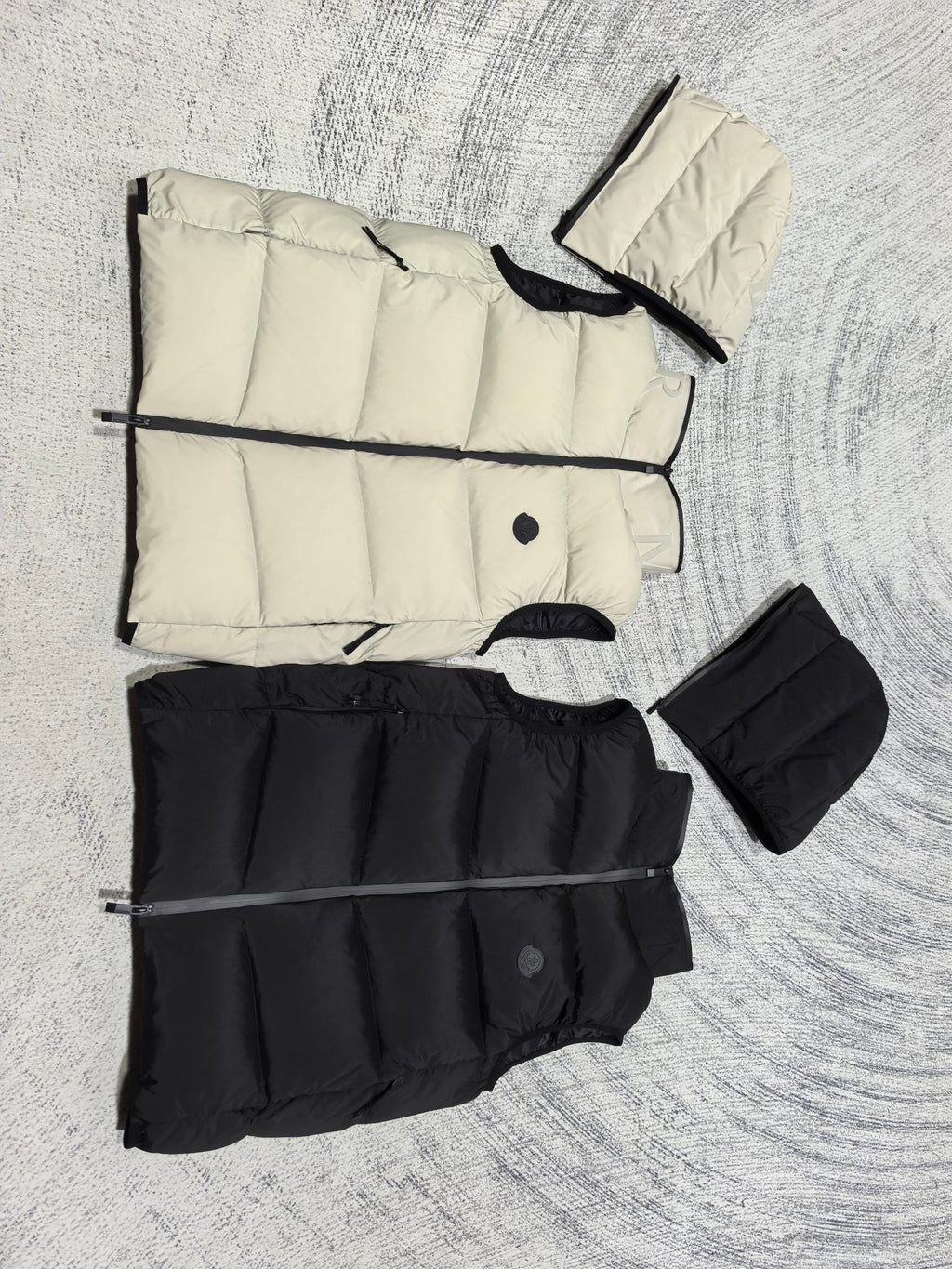 Flat lay hooded puffer vest set: light cream and black, stitched panels and zipper