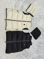 Flat lay hooded puffer vest set: light cream and black, stitched panels and zipper
