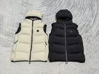 Quilted hooded puffer vests, light cream and black, hoods visible with zip-front