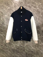 Dior varsity jacket with navy body, white sleeves, button front, and side pockets