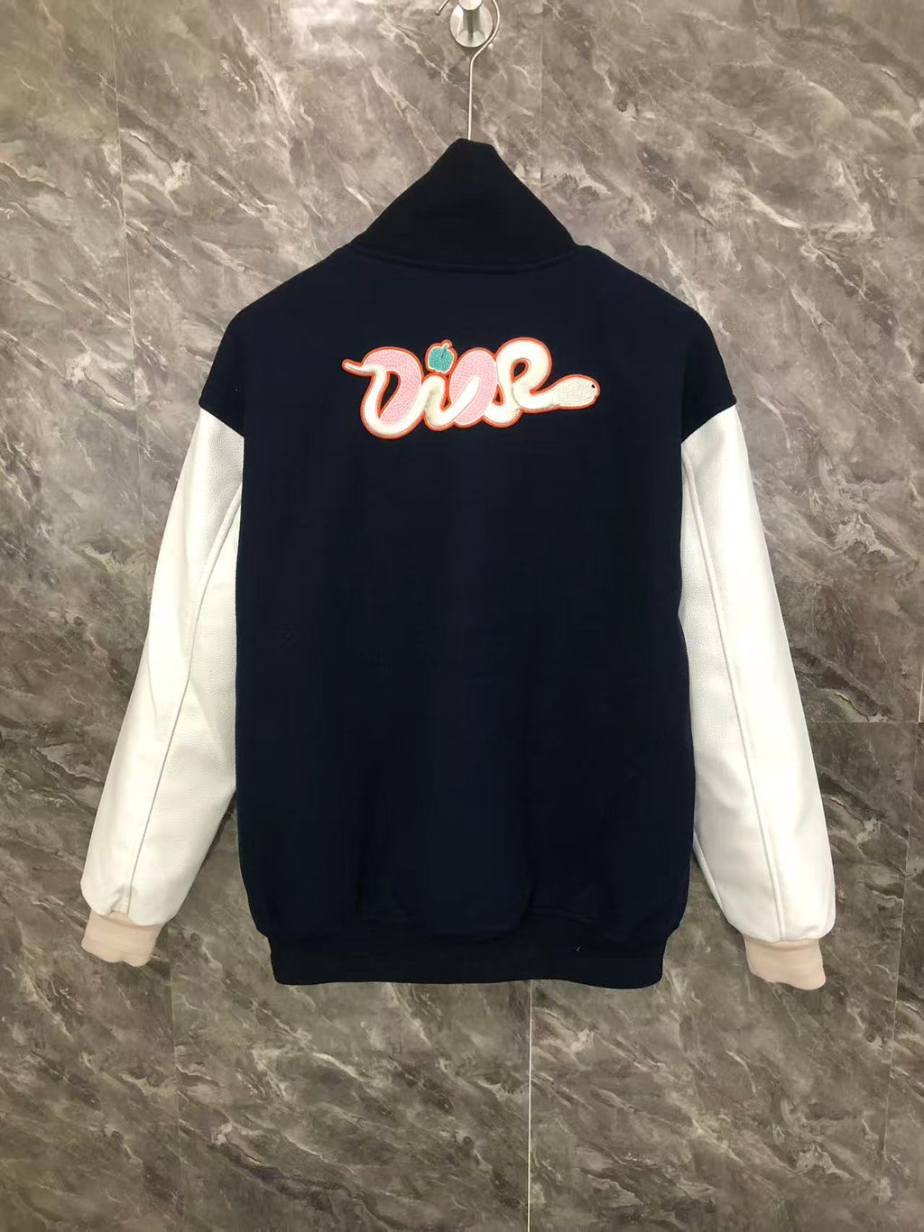 Dior varsity jacket with back “Diorise” graphic and white sleeves