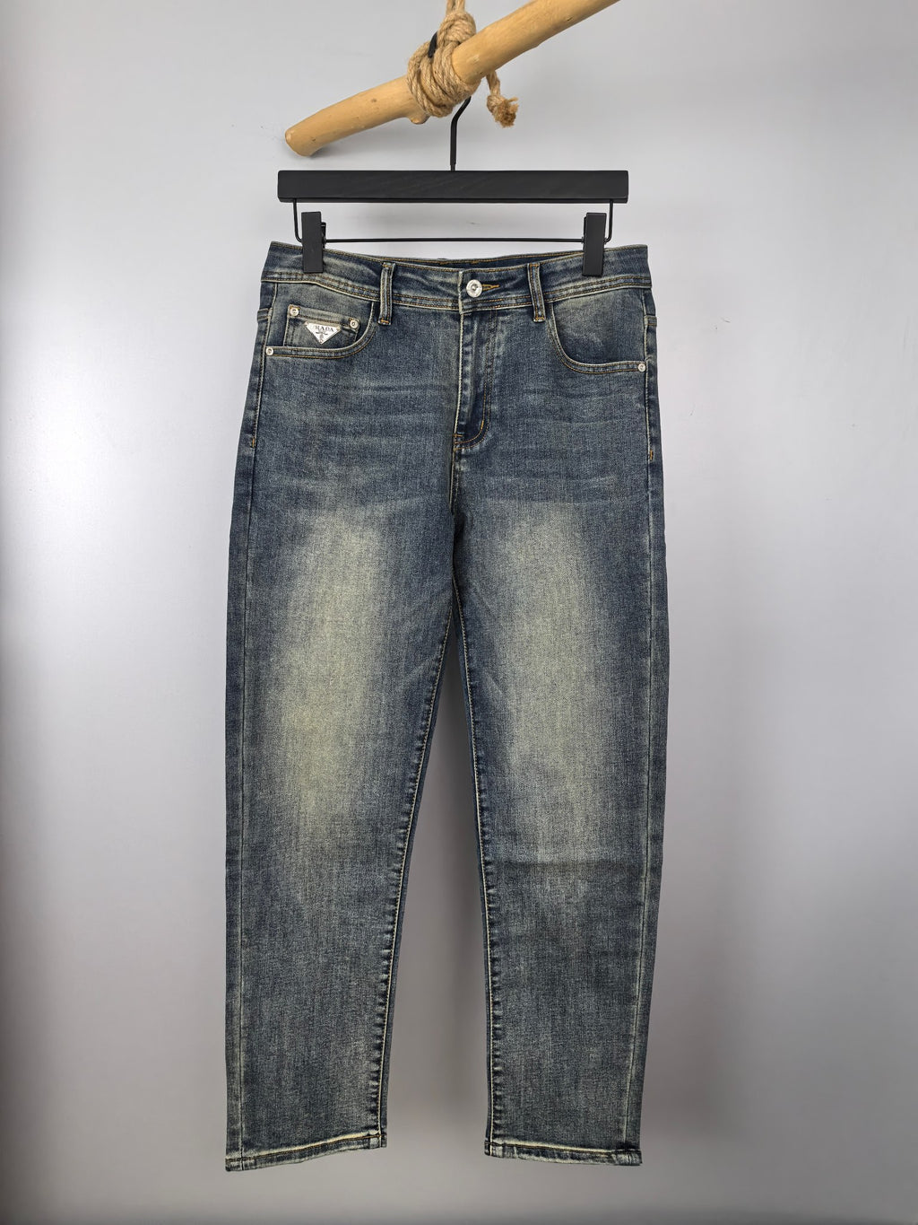 Prada denim pants in light wash blue with button fly and belt loops