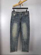 Prada denim pants in light wash blue with button fly and belt loops