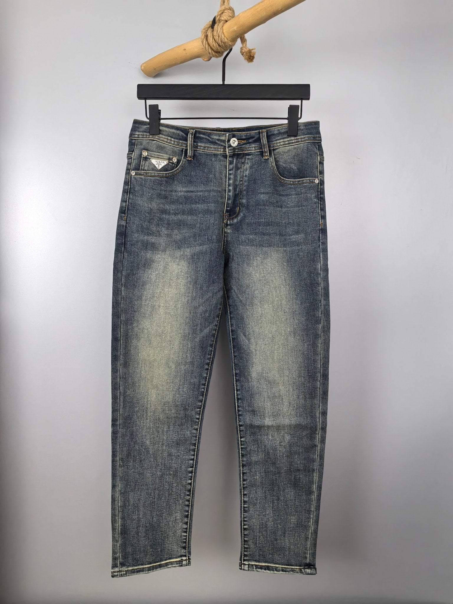 Prada denim pants in light wash blue with button fly and belt loops
