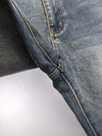 Prada denim pants side seam close-up with contrast yellow stitching