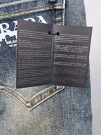 Prada denim pants care instruction tags attached to the waistband