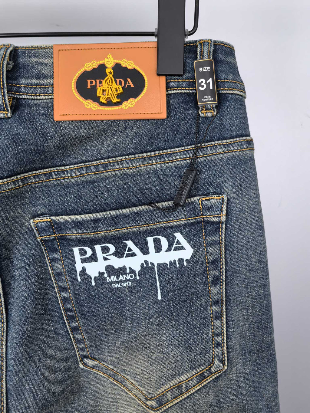 Prada denim pants back with logo patch and size 31 tag on waistband