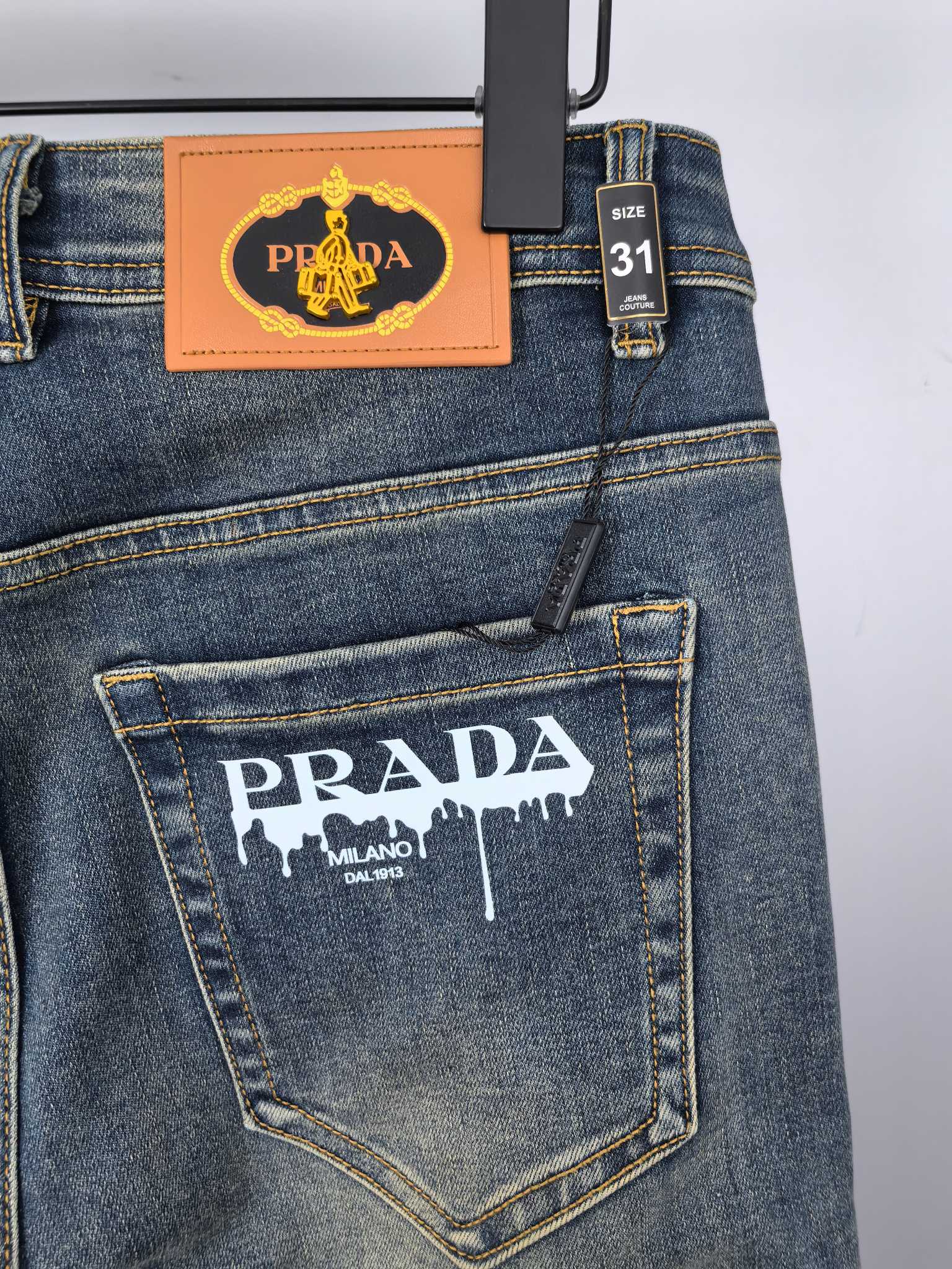 Prada denim pants back with logo patch and size 31 tag on waistband