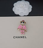 Pink Chanel doll charm keychain with star details and gold-tone accessories