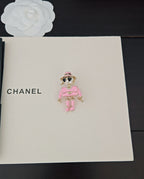 Pink doll charm keychain with sunglasses and gold-tone accents