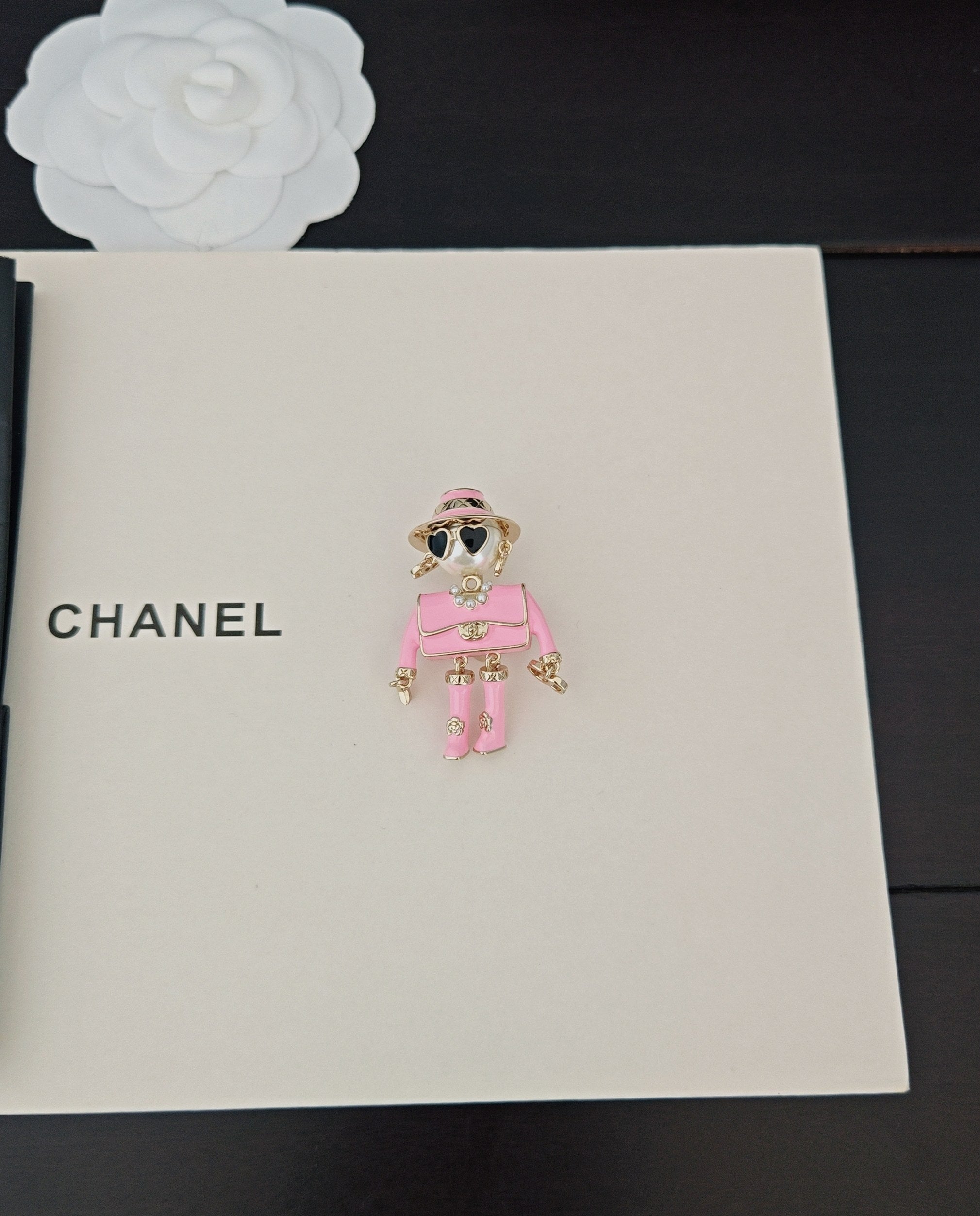 Pink doll charm keychain with sunglasses and gold-tone accents