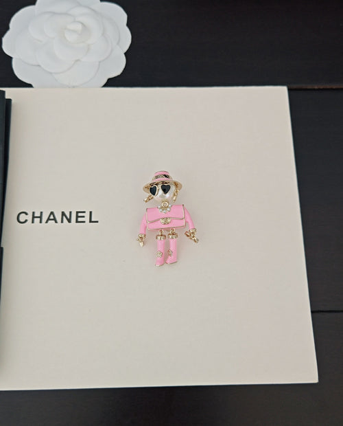 Pink doll charm keychain with sunglasses and gold-tone accents