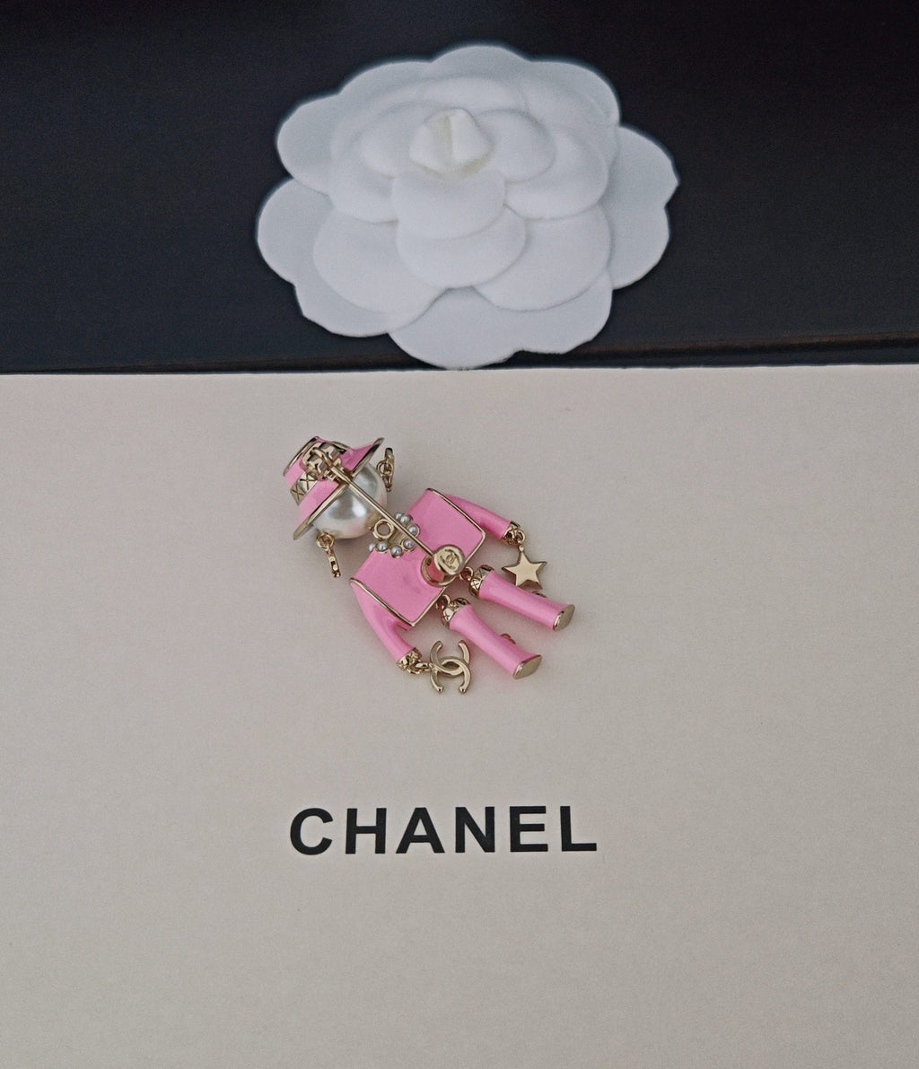 Pink Chanel doll charm keychain with backpack and gold-tone chain