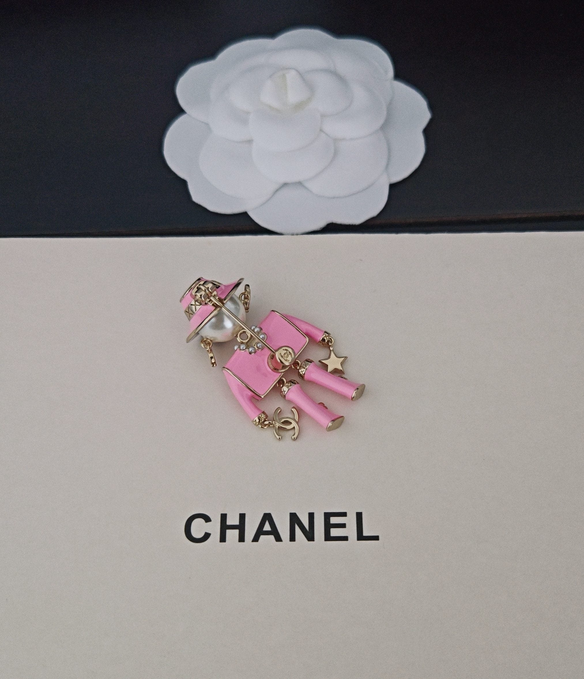 Pink Chanel doll charm keychain with backpack and gold-tone chain