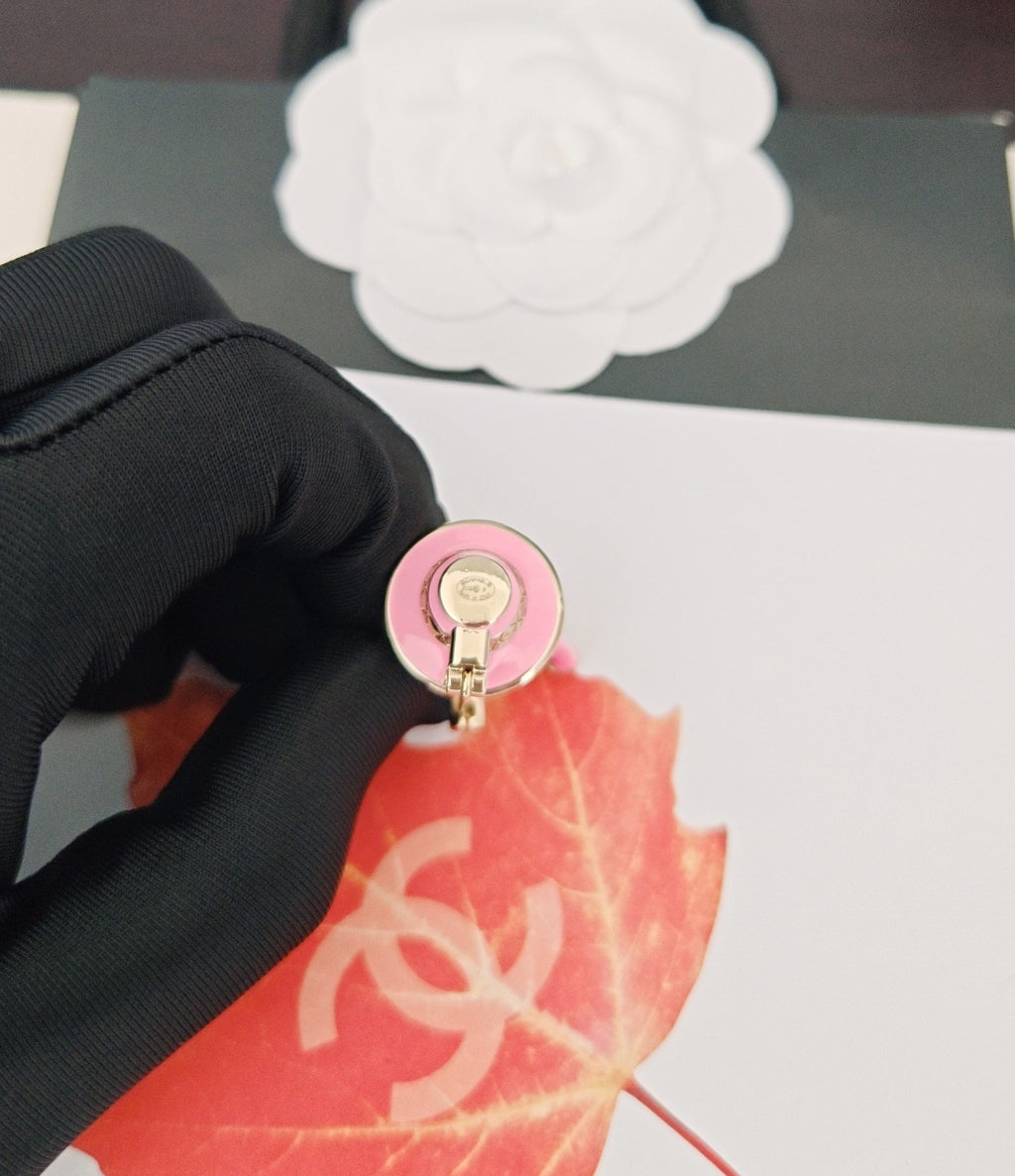 Pink Chanel charm keychain clasp with gold-tone ring and logo center