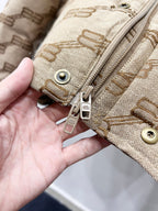 Balenciaga puffer jacket front zipper and snap hardware in beige with logo pattern