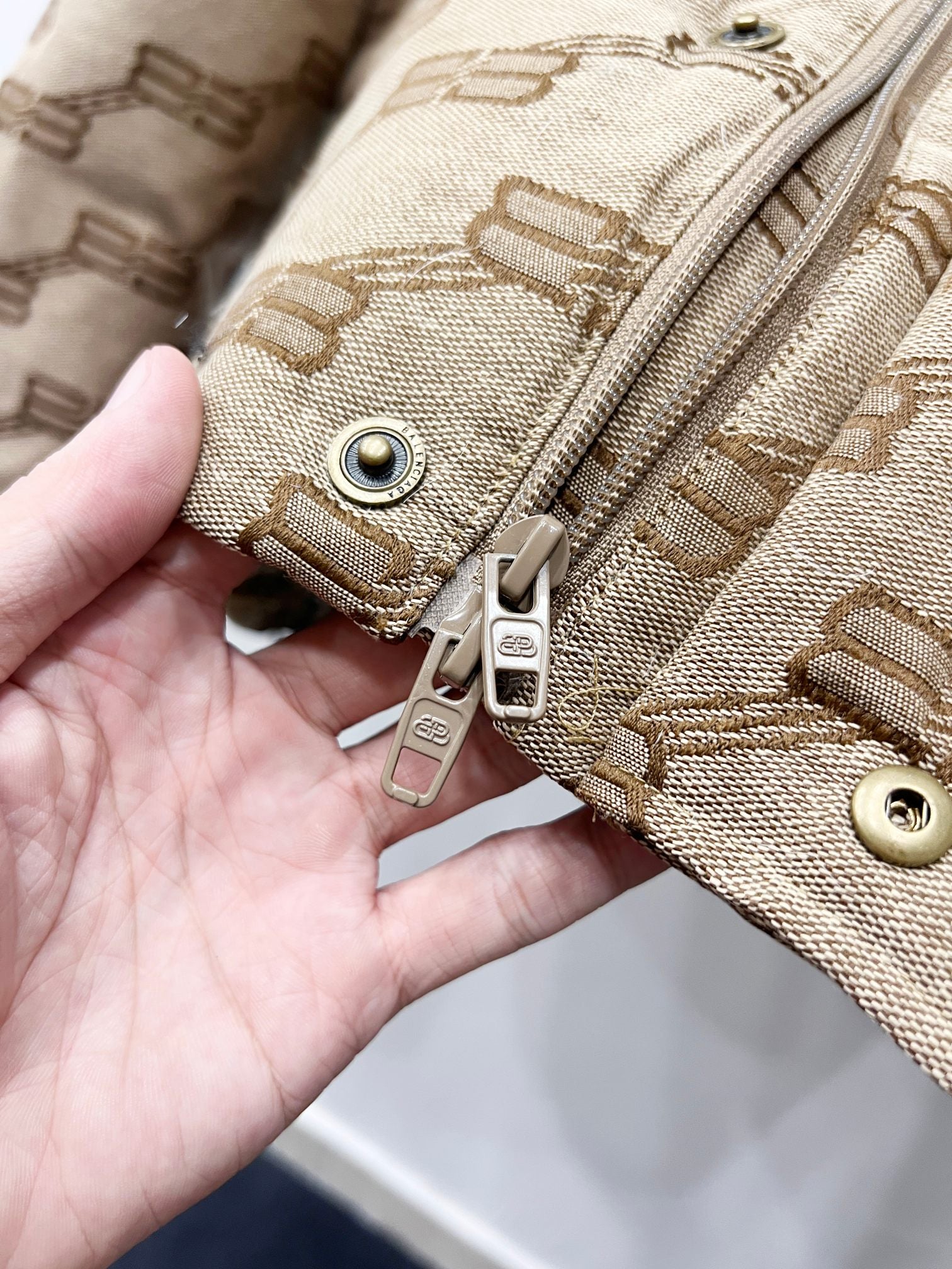 Balenciaga puffer jacket front zipper and snap hardware in beige with logo pattern