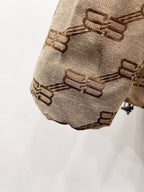 Balenciaga puffer jacket sleeve hem in beige with repeating logo pattern