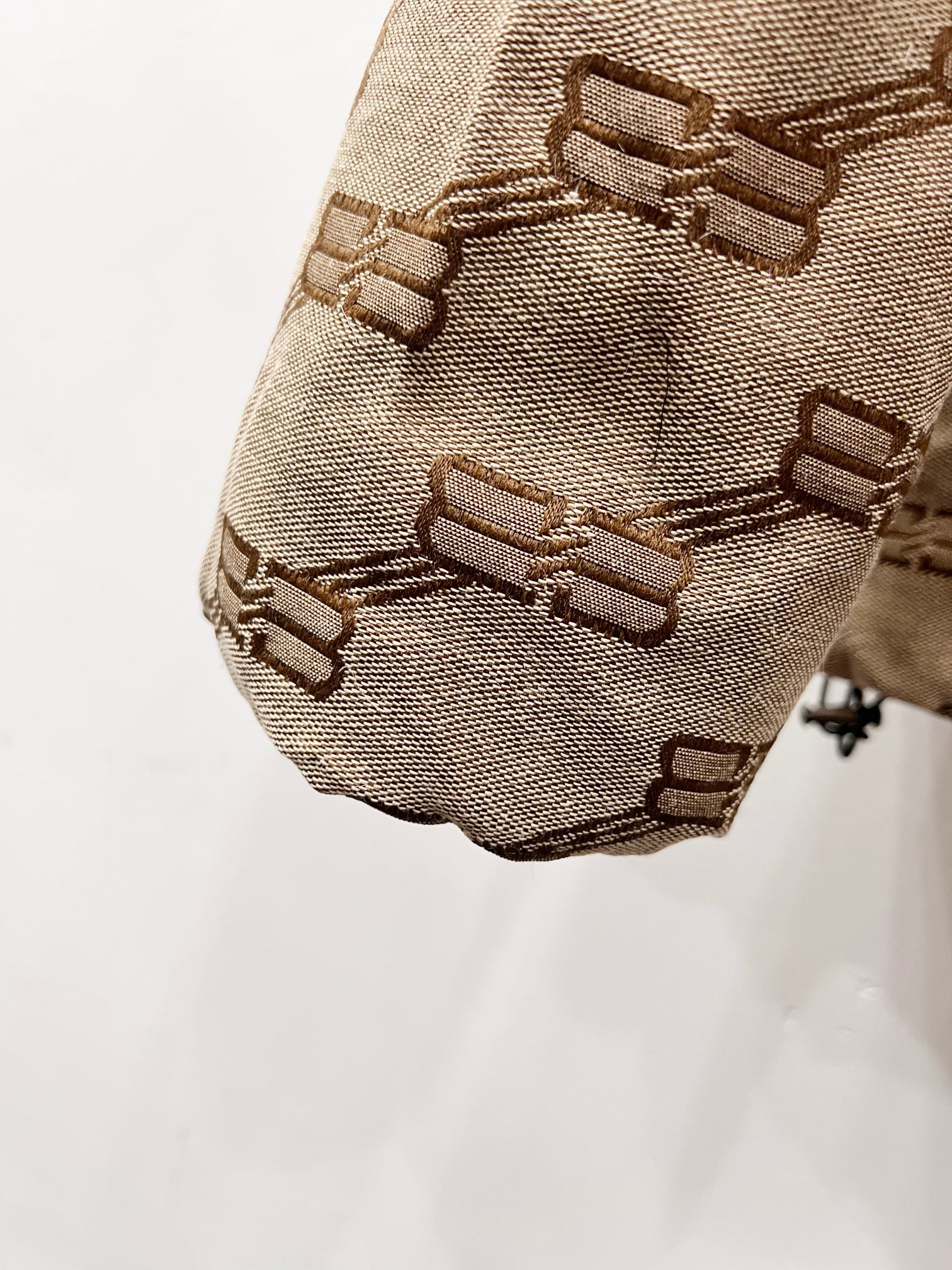 Balenciaga puffer jacket sleeve hem in beige with repeating logo pattern