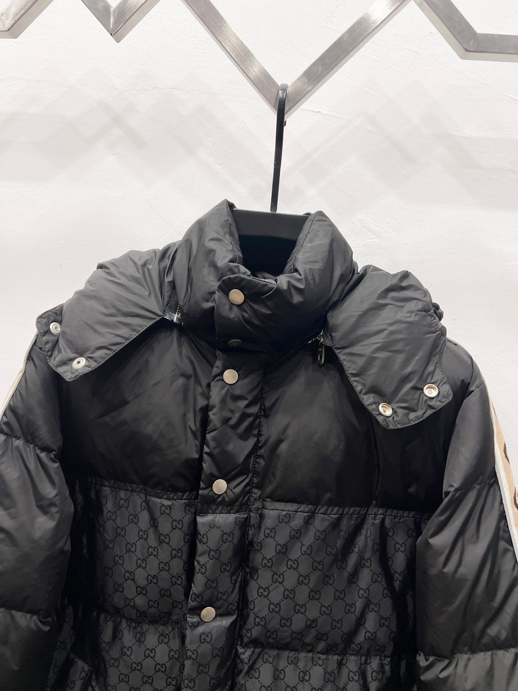 Dark quilted puffer jacket with hood and snap-button placket