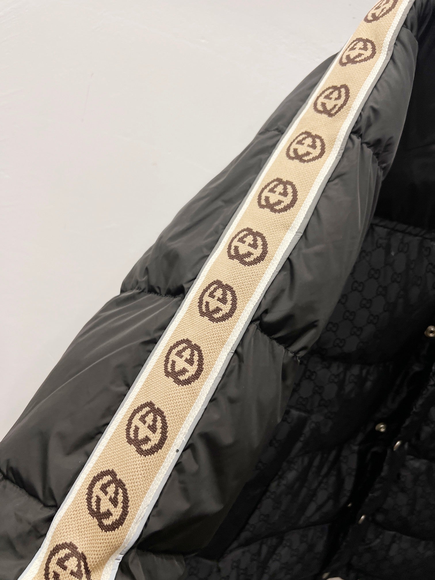 Dark puffer jacket with hood and logo trim stripe on sleeve