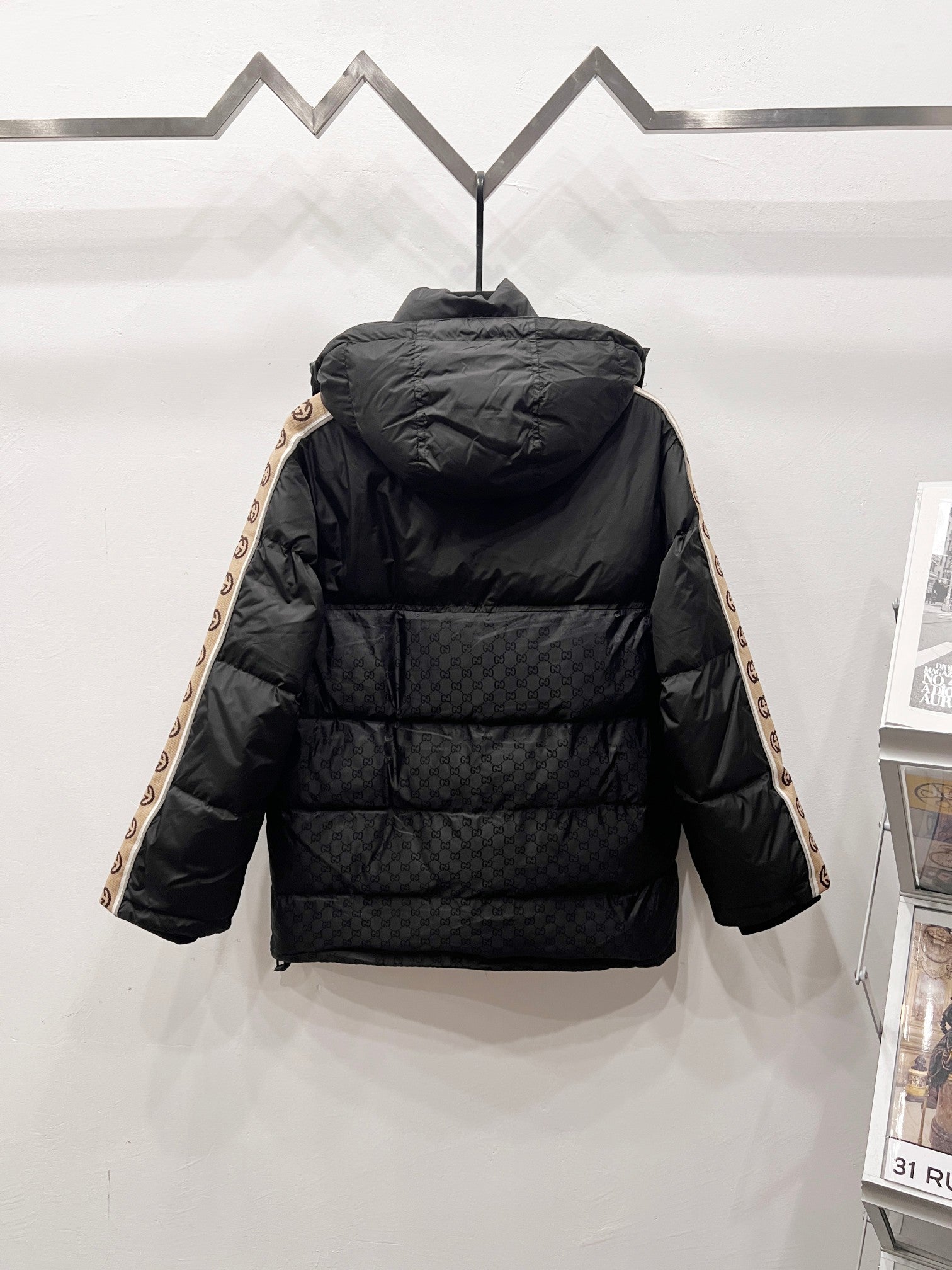 Dark puffer jacket with attached hood and quilted front panel