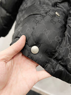 Dark hooded puffer jacket fabric with round snap button and monogram texture