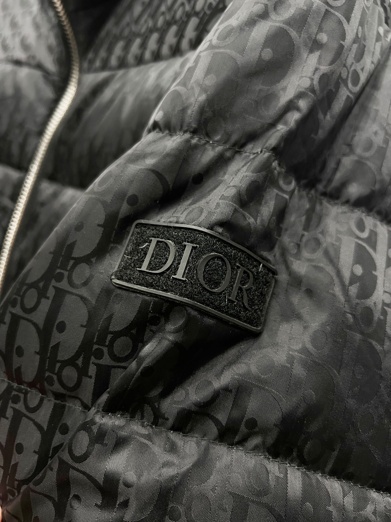 Dior logo patch on quilted puffer jacket fabric
