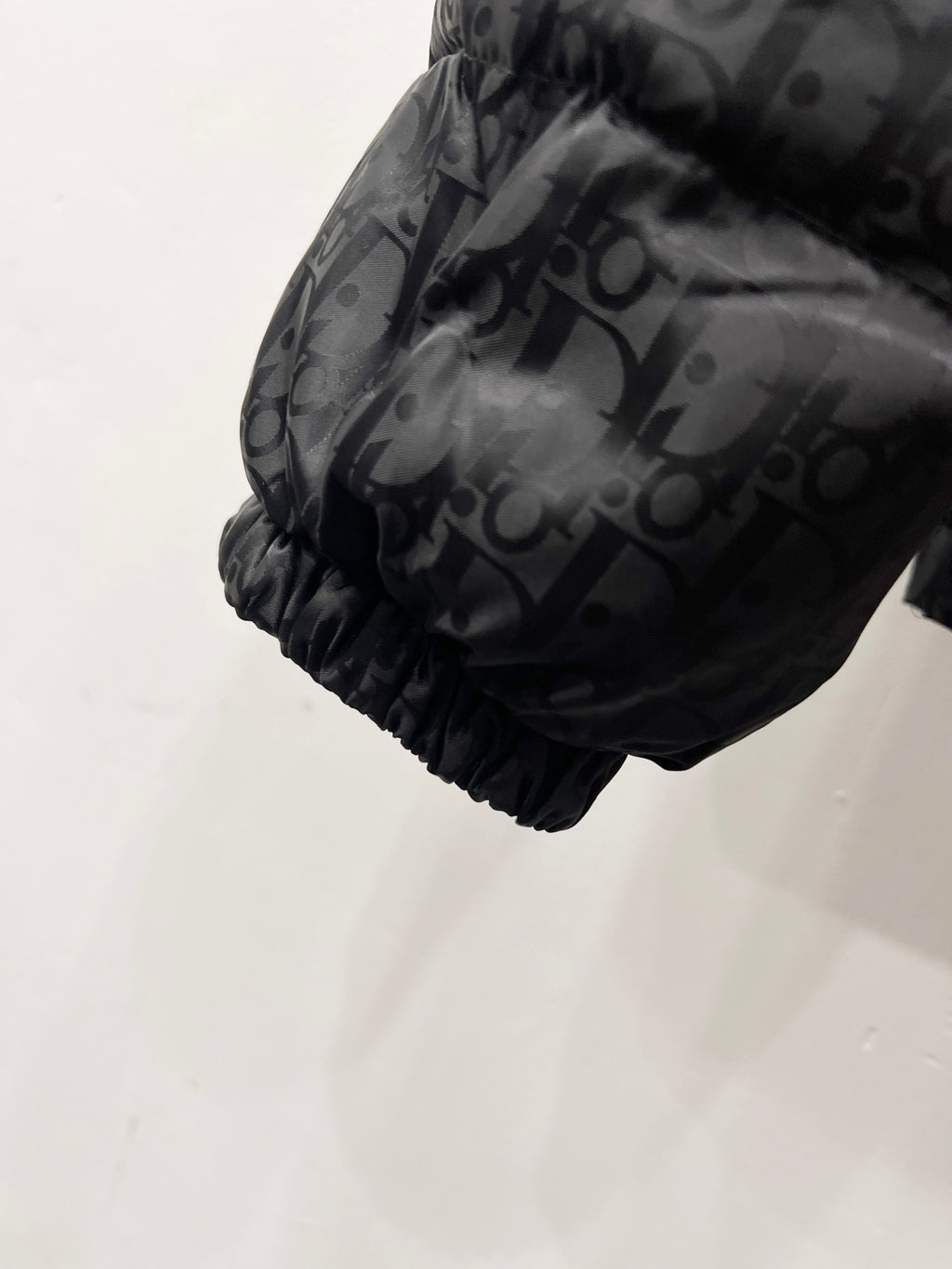 Quilted puffer jacket sleeve hem with gathered cuff and monogram print