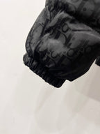Quilted puffer jacket sleeve hem with gathered cuff and monogram print