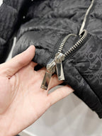 Quilted puffer jacket close-up of zipper pull and stitching