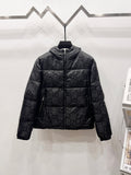 Gucci puffer jacket in dark fabric with allover GG pattern and zip front