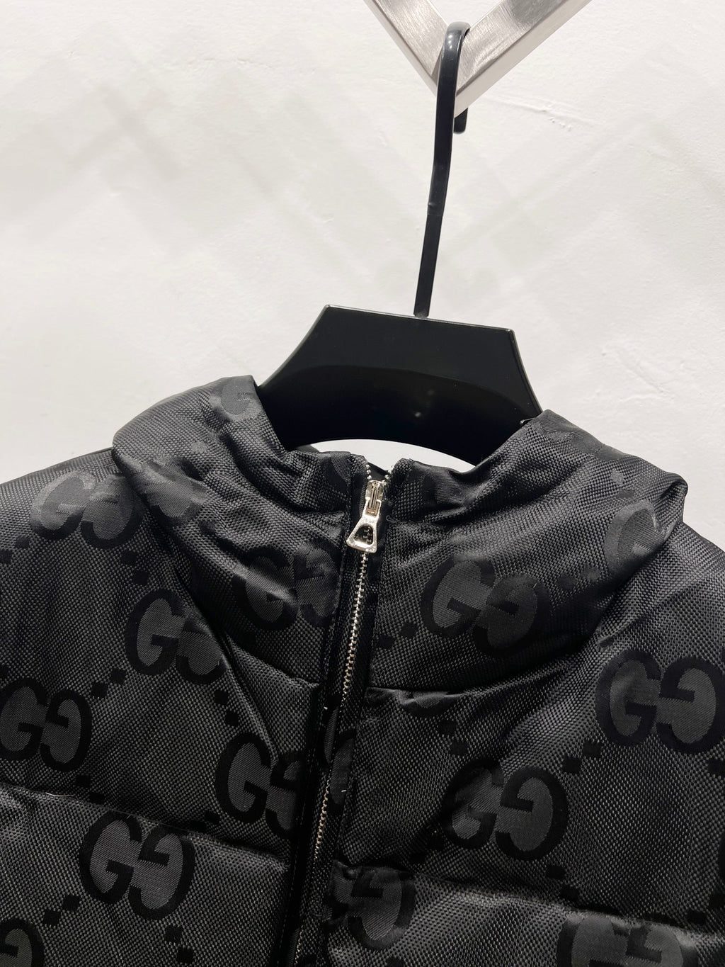 Gucci hooded puffer jacket collar detail with GG monogram and front zipper