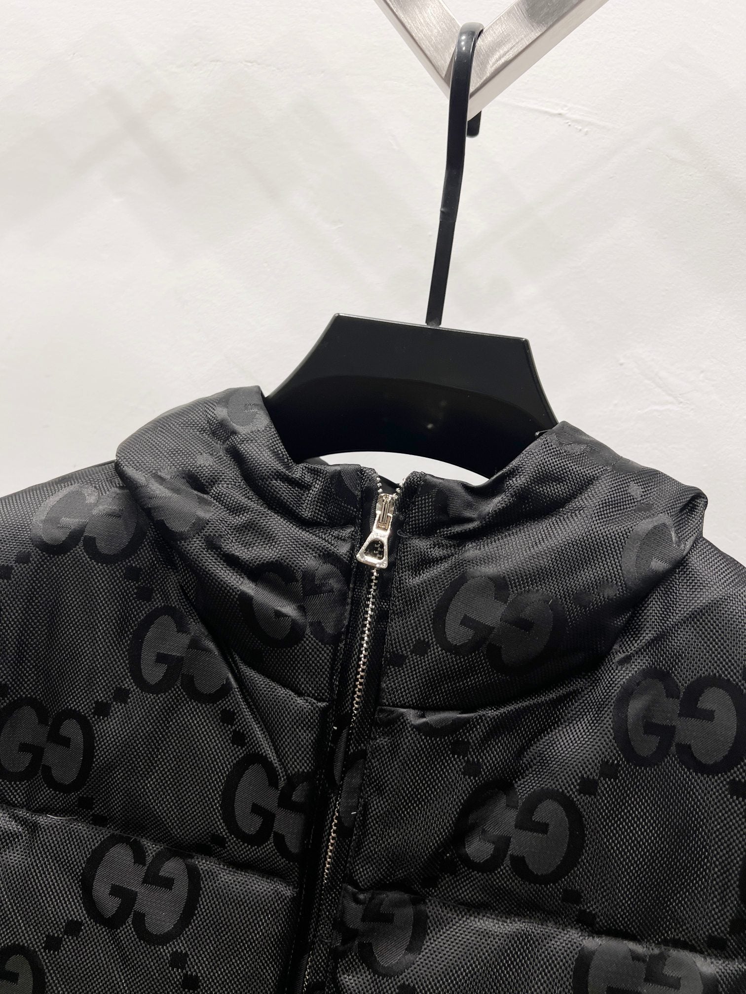 Gucci hooded puffer jacket collar detail with GG monogram and front zipper