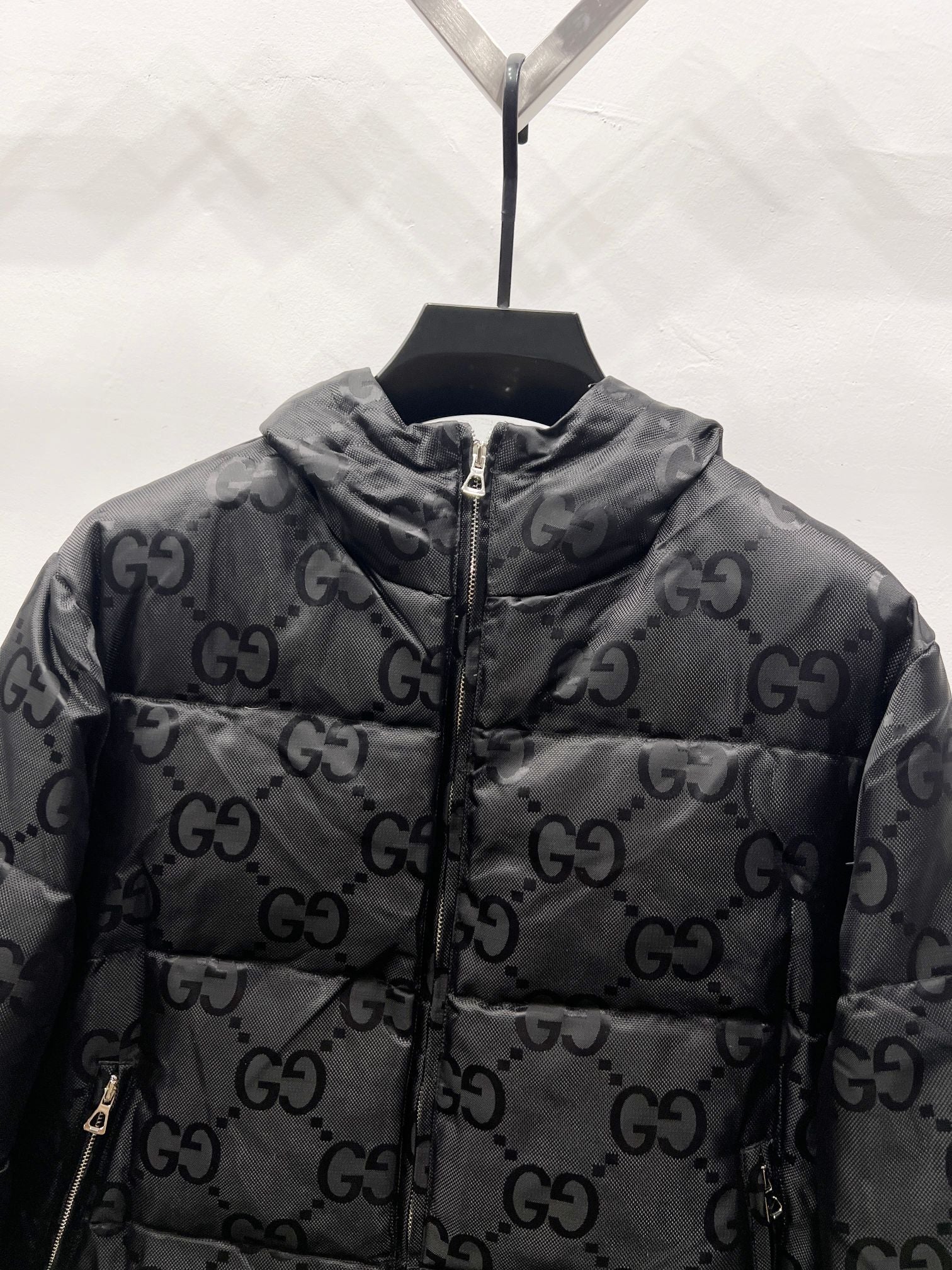 Gucci hooded puffer jacket close-up with GG monogram allover and zip front