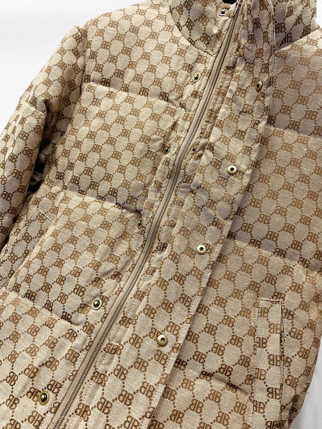 Gucci puffer jacket detail: beige monogram fabric, front zipper, snap buttons