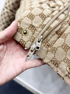 Gucci puffer jacket cuff detail: beige monogram fabric with snap buttons and zipper