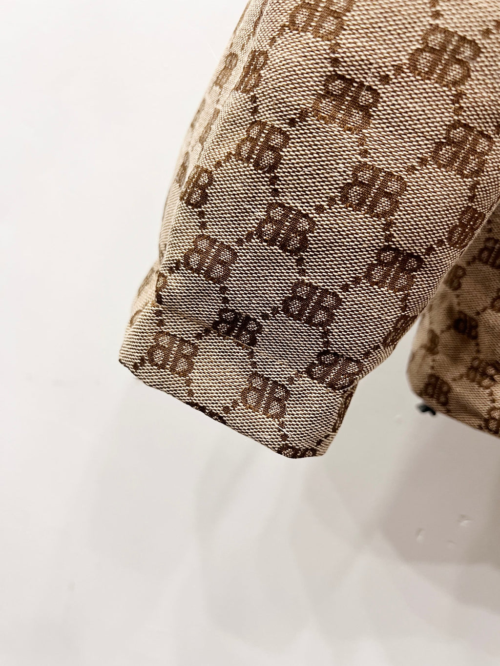 Gucci puffer jacket sleeve end detail in beige monogram fabric